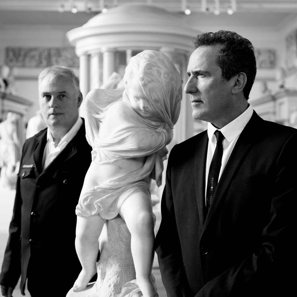 Picture of OMD in black and white by a statue