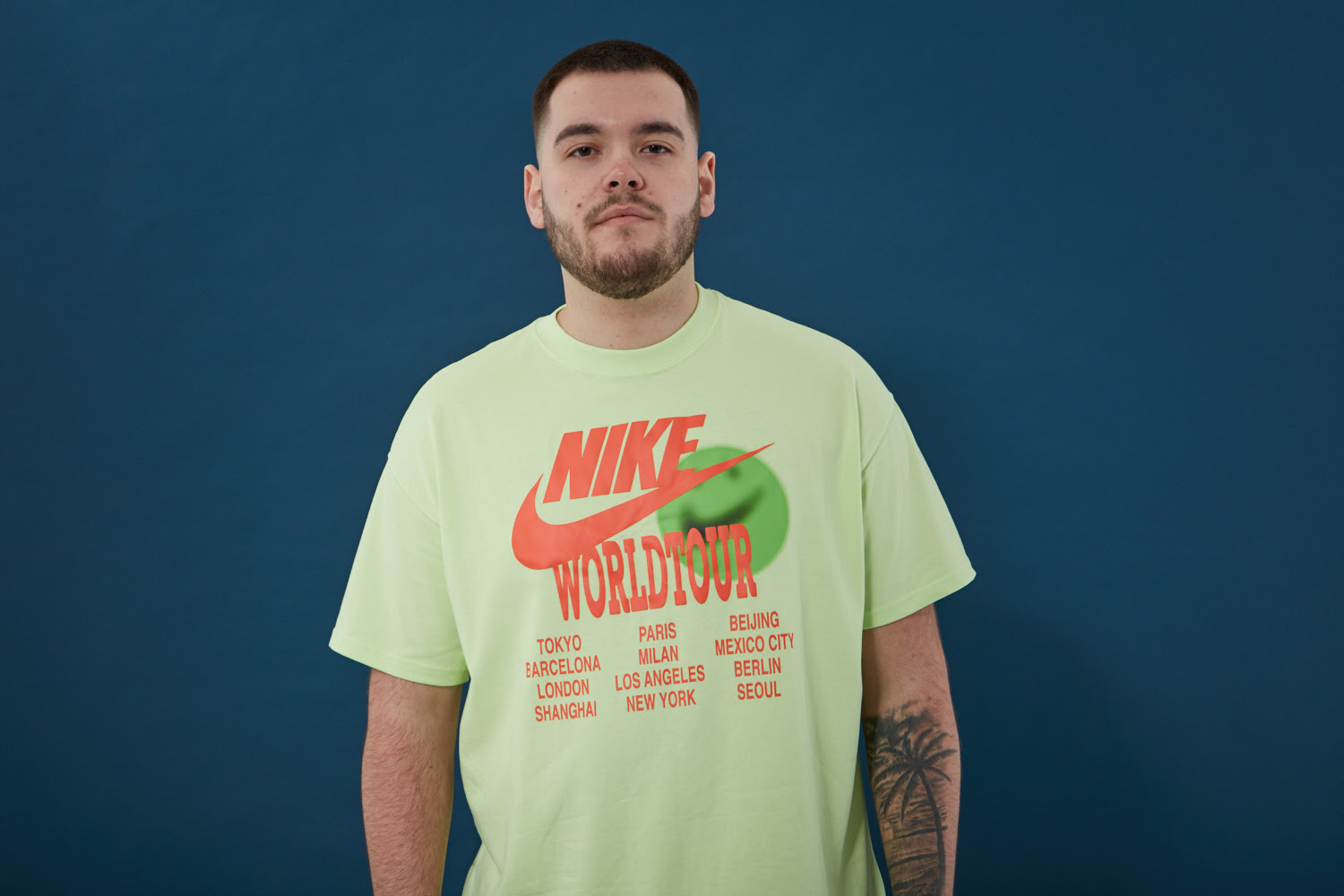 Navos in a green Nike world tour tshirt