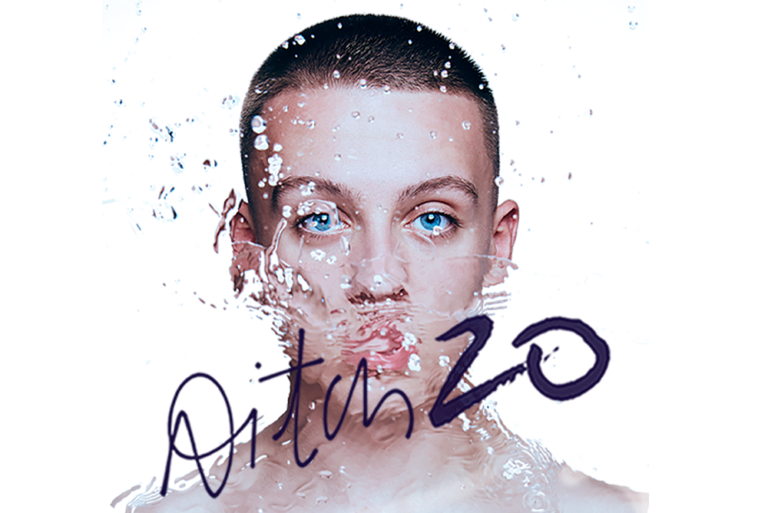Aitch with water splashing on him