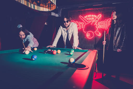Mexican dogs band members playing pool