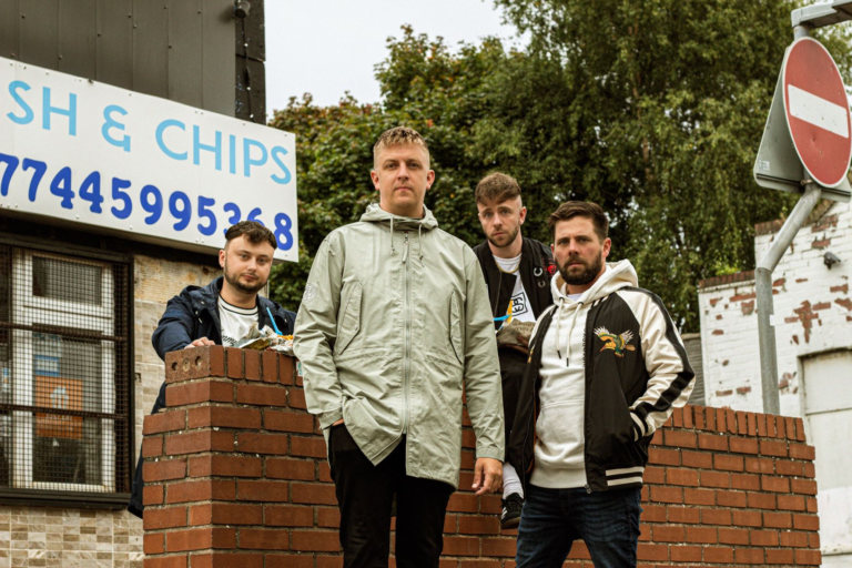 The Reytons stood by a brick wall outside a fish and chip shop