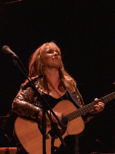 Gretchen Peters playing her guitar on stage