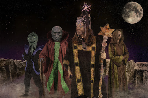 Henge band dressed up as aliens and monks under a full moon