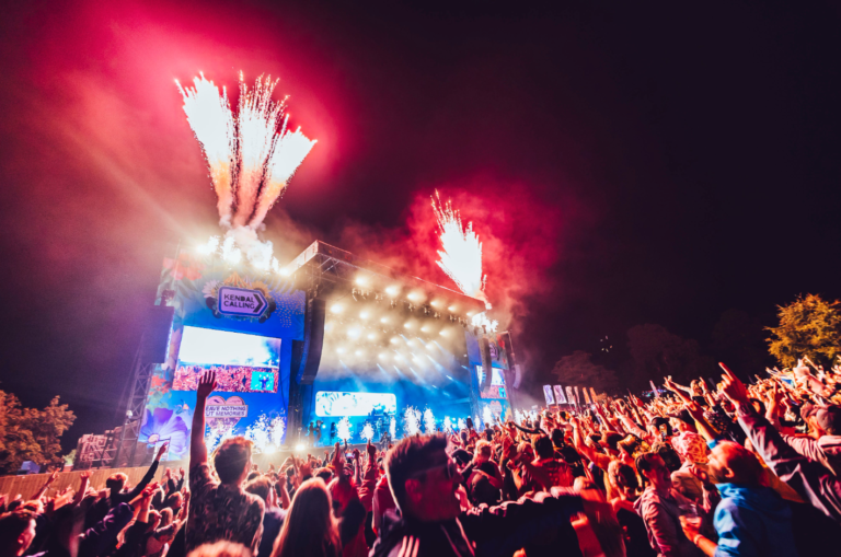 A huge crowd in front of the Kendal Calling main stage as fireworks go off over the stage