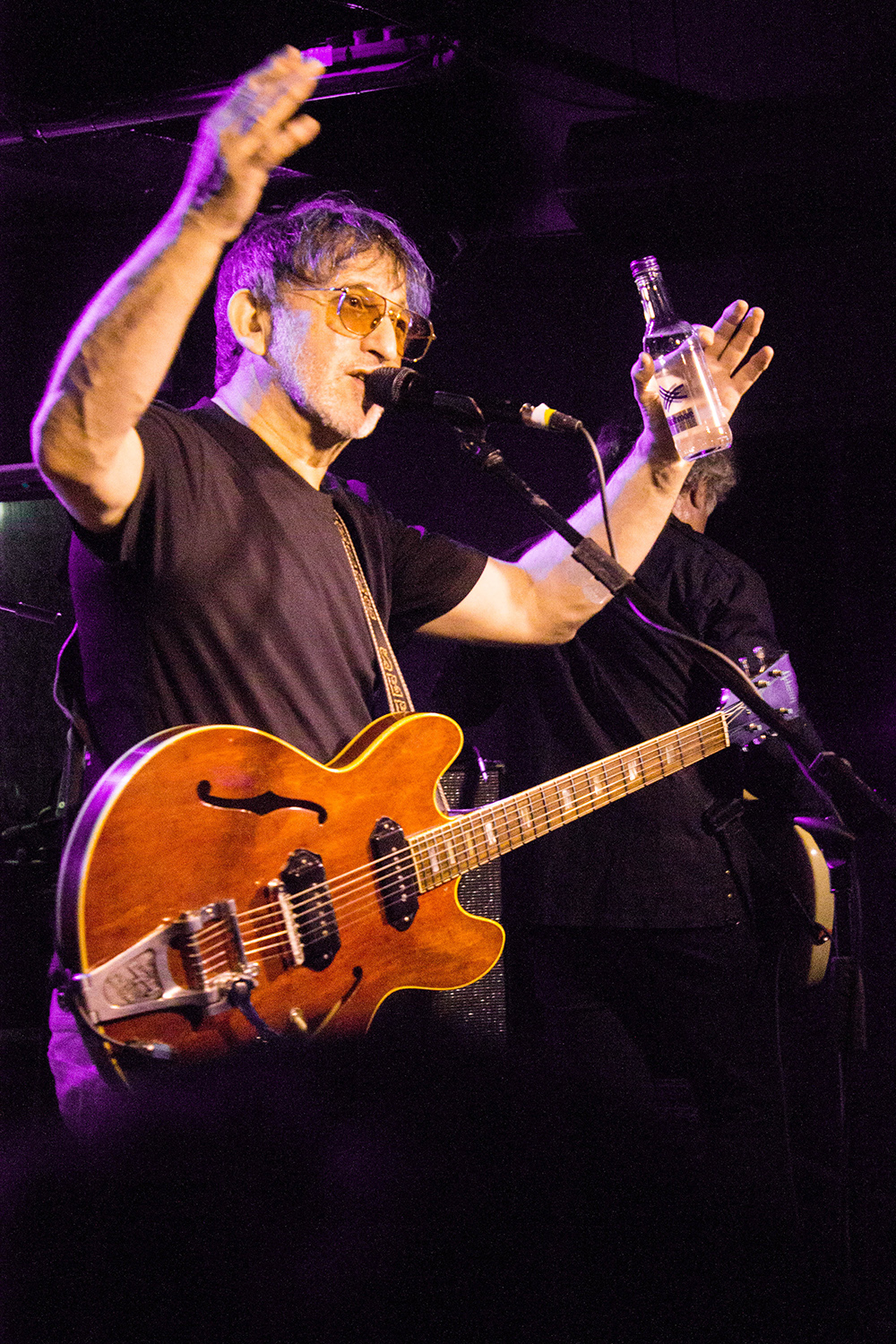 Ian Broudie from the Lightning seeds with his hands up on stage at the cavern