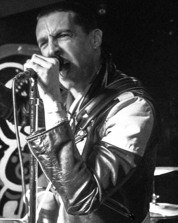 Miles Kane singing on stage at the Jacaranda Club in Liverpool