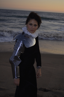 Sarabeth Tucek on a beach with knights armour on