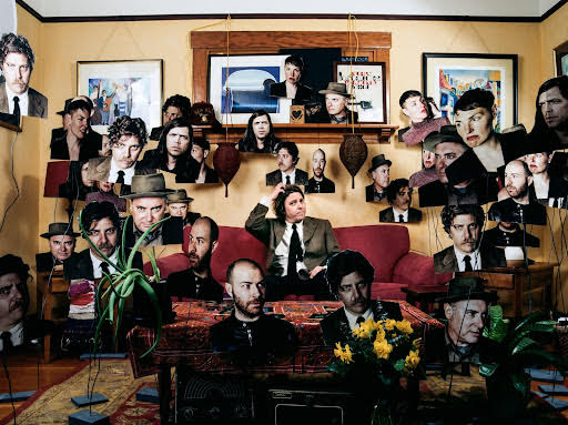 Collage of faces surrounding Von Wildenhaus who is sitting on a sofa