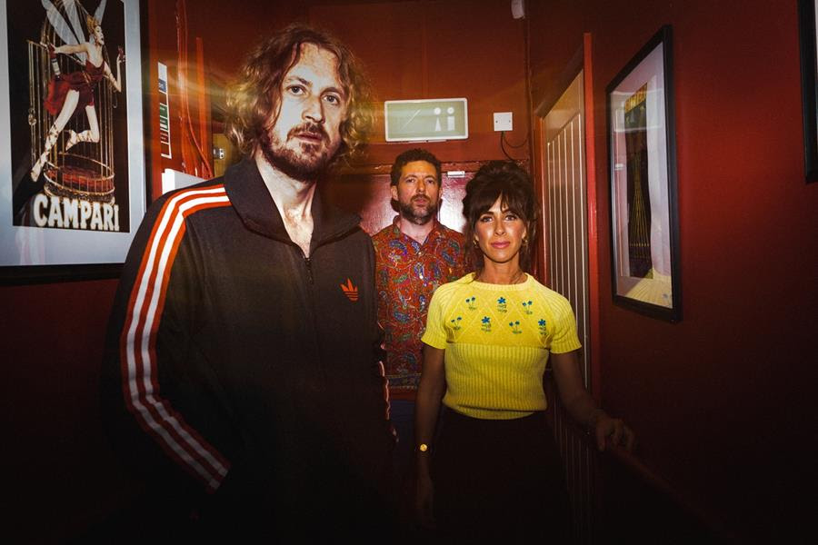 The Zutons stood in a corridor with red walls