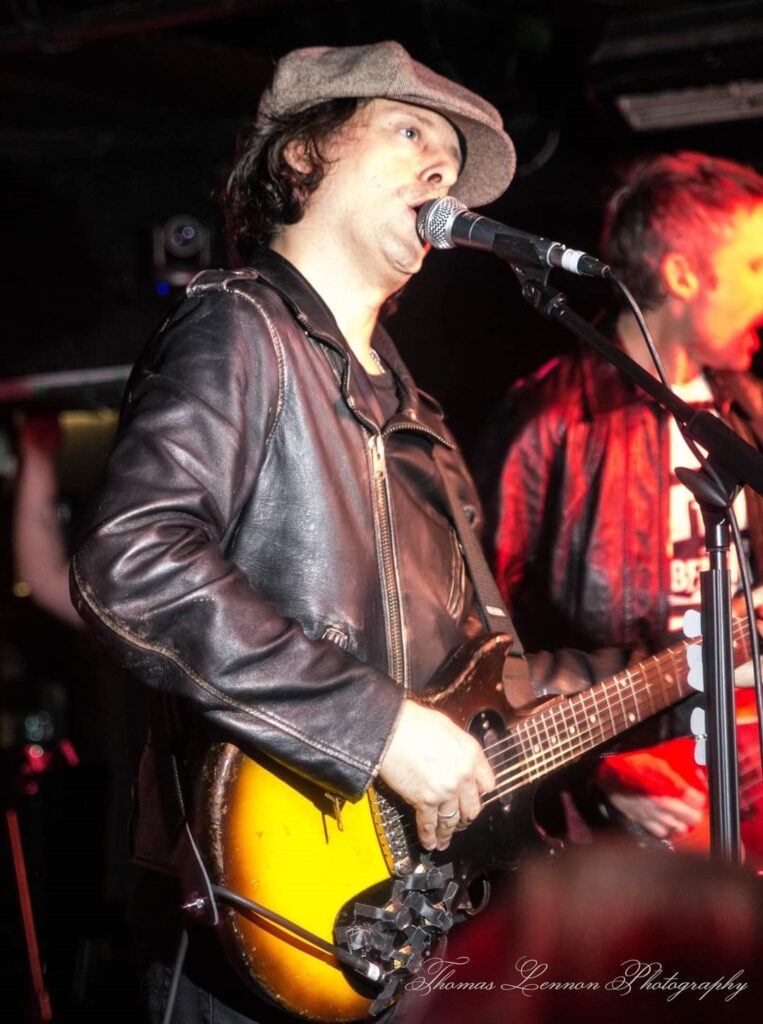 Carl Barat from the Libertines singing on stage at the cavern club liverpool