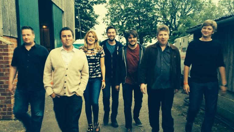 The southmartins band ina line walking down the road
