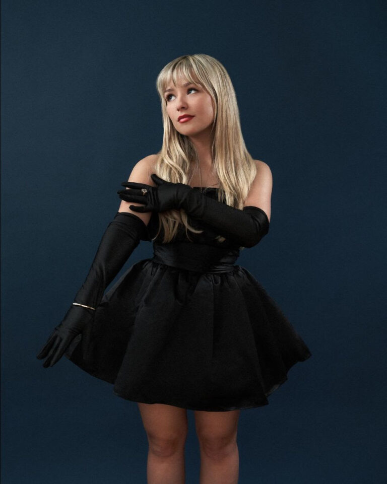 Connie Talbot in a black cocktail dress and gloves