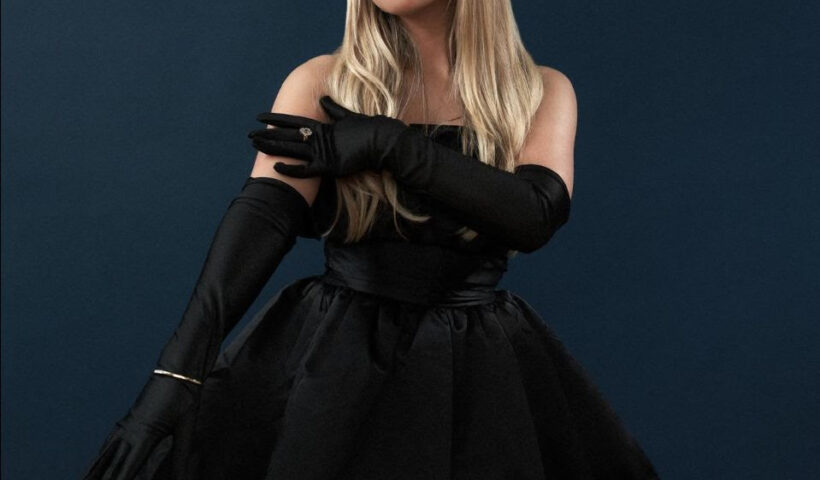 Connie Talbot in a black cocktail dress and gloves