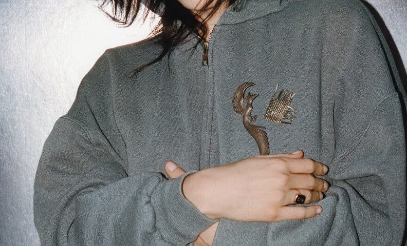 Lorde stood in a grey hoodie