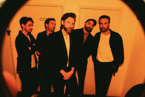 Everyone says Hi bathed in an orange glow as seen through a camera lens
