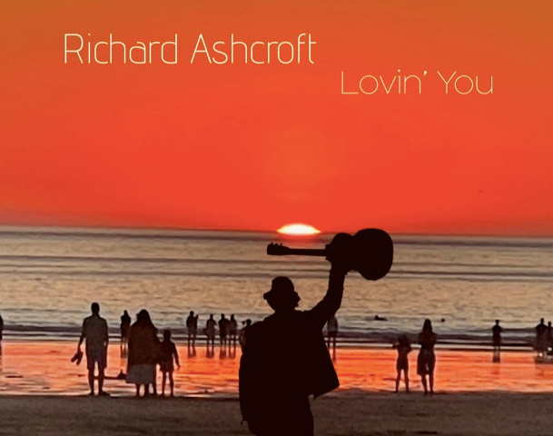 Cover of the new album Lovin you by Richard ashcroft showing a man holding up a guitar on a beach at sunset