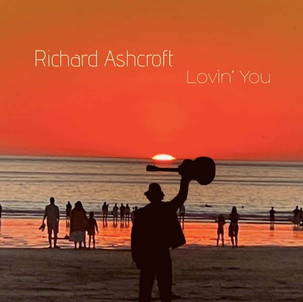 Cover of the new album Lovin you by Richard ashcroft showing a man holding up a guitar on a beach at sunset