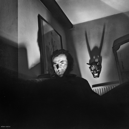 Hugh Cornwell in a the shadows with only his face showing