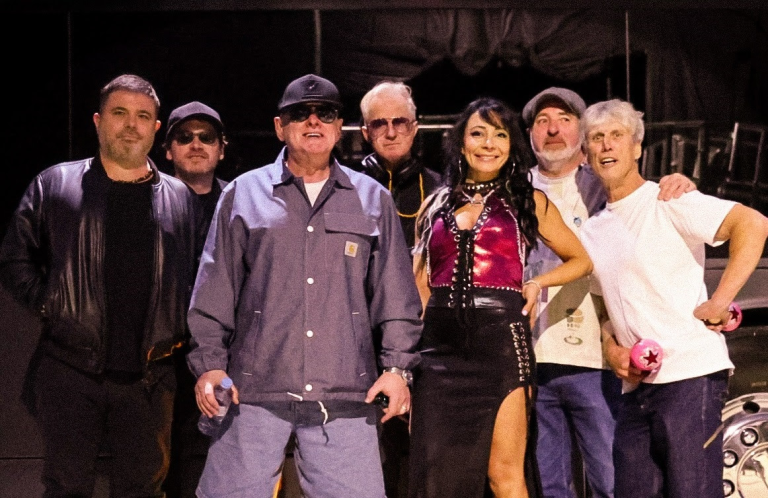 Happy Mondays on stage in a line