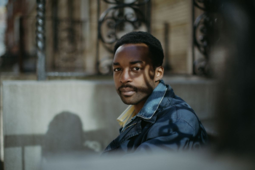 Jalen Ngonda looking at the camera in a candid shot with a denim jacket on