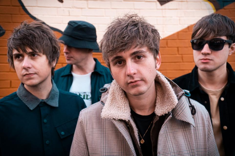 The sherlocks posing by a wall