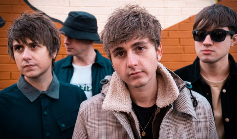The sherlocks posing by a wall