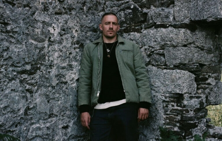 Dermot Kennedy stood with his back to a wall