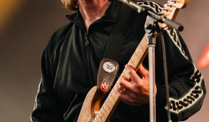 Dave McCabe singing on stage and playing his electric guitar