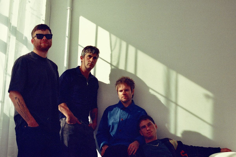 Enter Shikari stood by a window with the sun coming through it