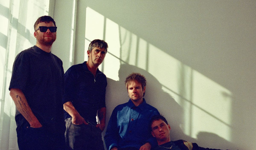 Enter Shikari stood by a window with the sun coming through it