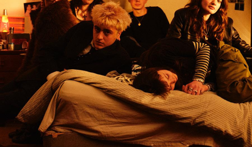 Man/Woman/Chainsaw all on a bed in a flat