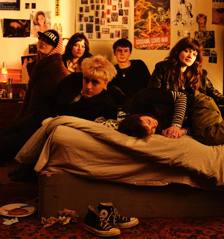 Man/Woman/Chainsaw all on a bed in a flat