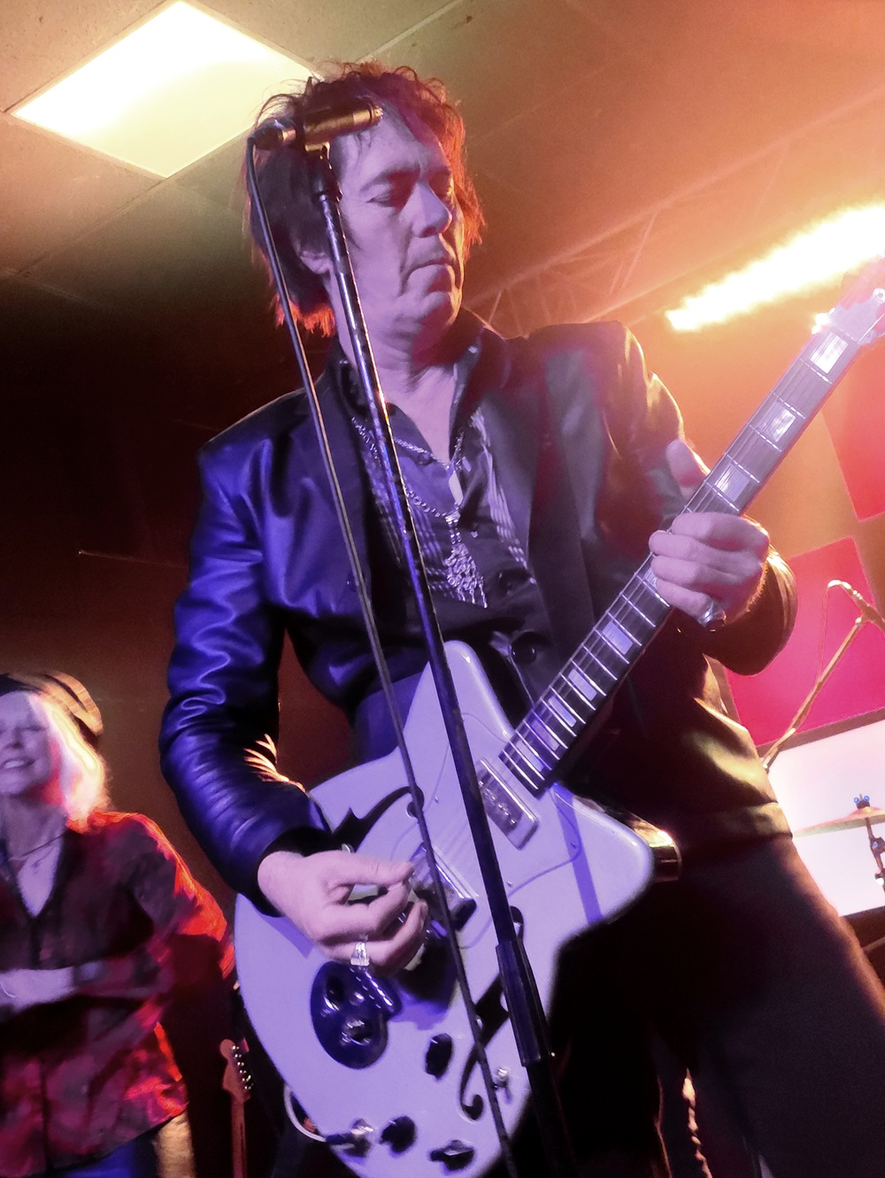 Jim Jones on stage playing his electric guitar